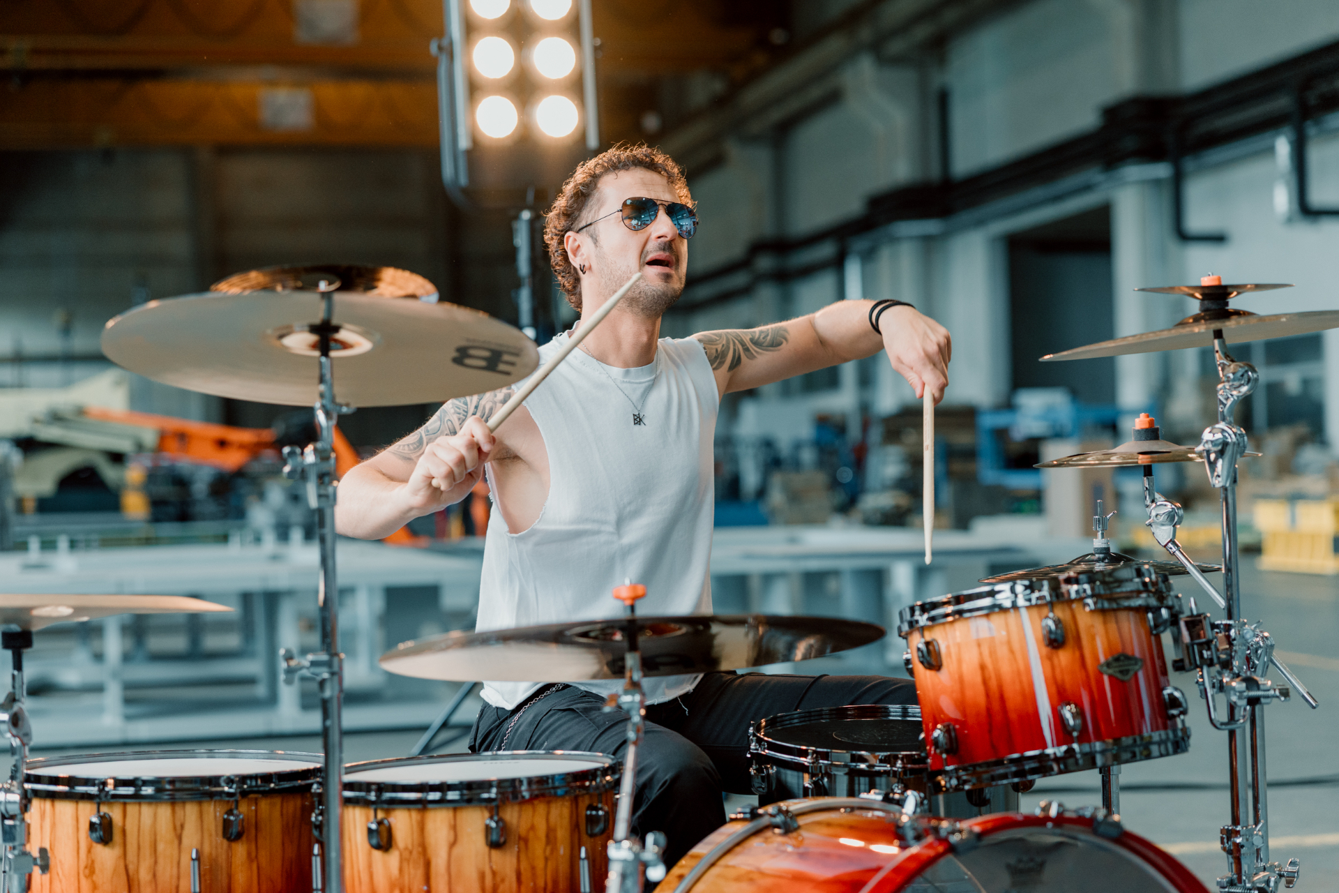 Drummer Jure performing behind a drum kit during the video shoot.