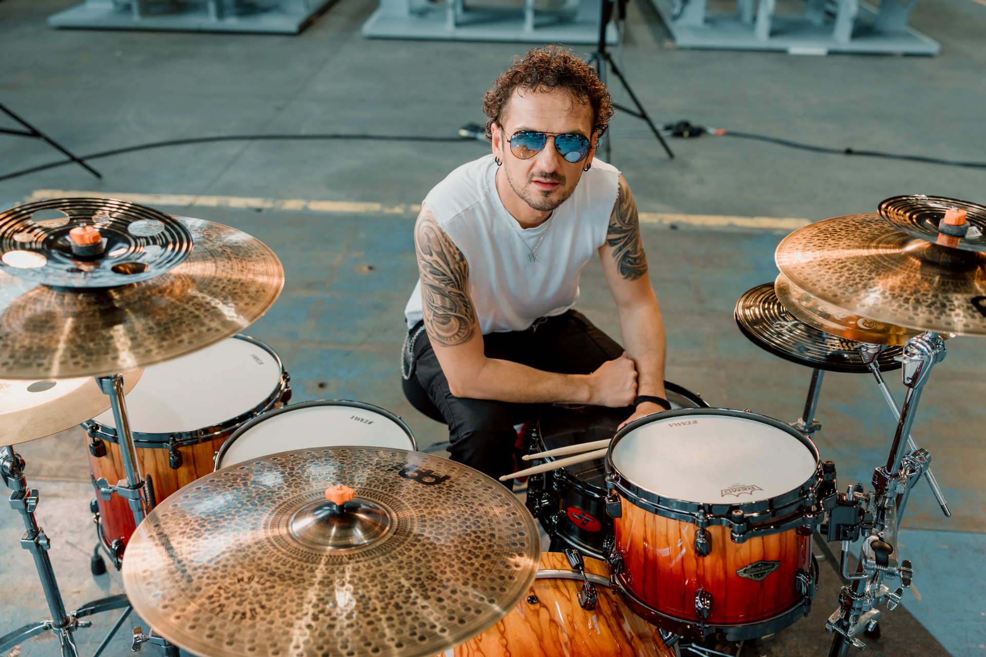 Jure seated at the drum kit looking toward the camera during the shoot.