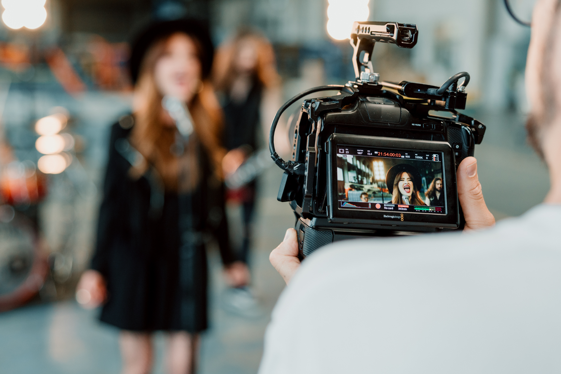 A camera monitor capturing Kati singing during the Grit Cathedral video shoot.