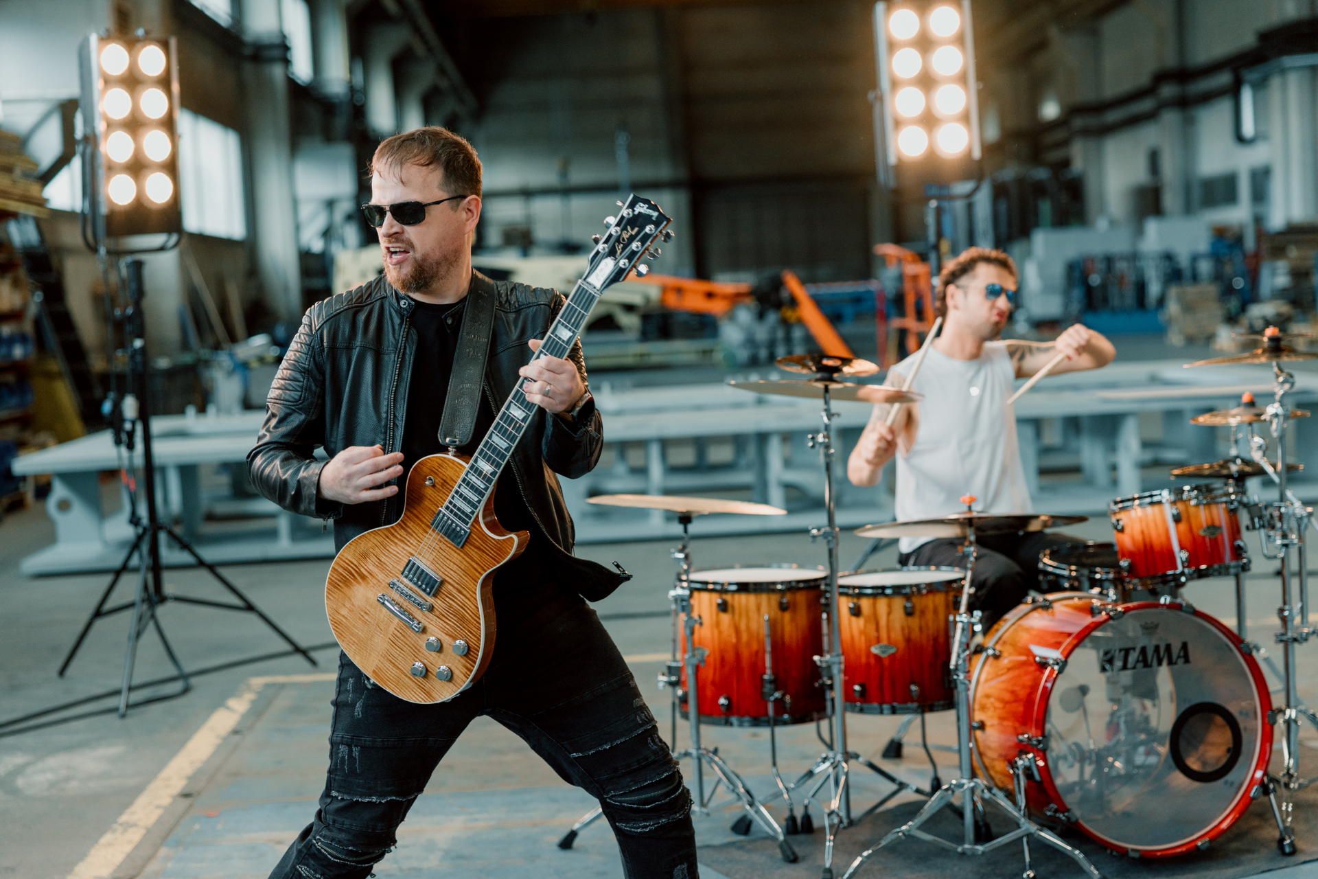 J.T. playing guitar in the foreground with Jure on drums behind him during the video shoot.